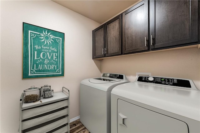 washroom featuring light wood-style flooring, cabinet space, baseboards, and washer and dryer