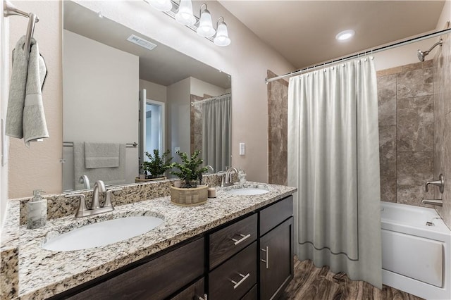bathroom with double vanity, visible vents, a sink, and shower / bathtub combination with curtain