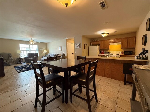 6297/6299 W Milliken Bnd, Fayetteville, AR 72704 - dining area featuring light tile patterned flooring, a ceiling fan, and visible vents