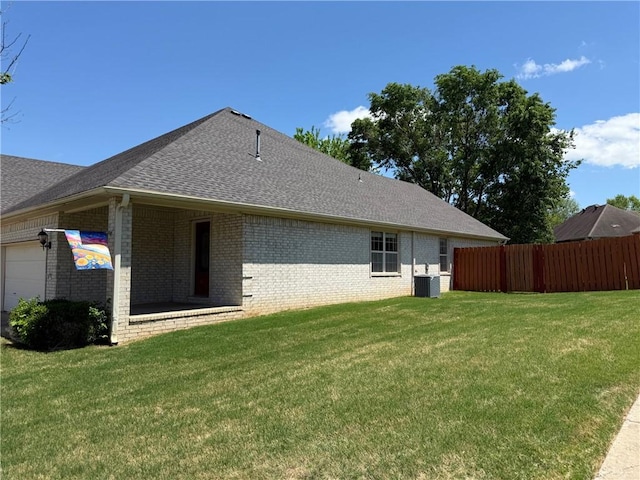 6297/6299 W Milliken Bnd, Fayetteville, AR 72704 - rear view of property featuring a yard, brick siding, fence, cooling unit, and a garage