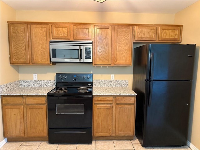 6297/6299 W Milliken Bnd, Fayetteville, AR 72704 - kitchen with black appliances, light stone counters, and brown cabinets