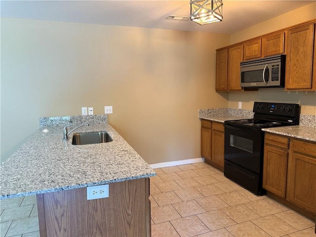 6297/6299 W Milliken Bnd, Fayetteville, AR 72704 - kitchen with a peninsula, a sink, brown cabinetry, electric range, and stainless steel microwave