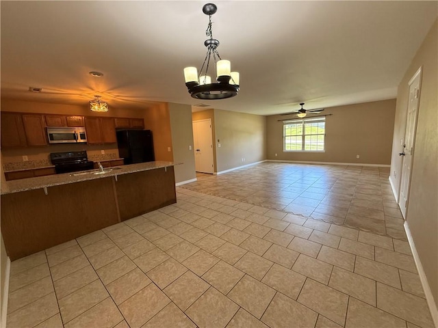6297/6299 W Milliken Bnd, Fayetteville, AR 72704 - kitchen with baseboards, brown cabinetry, light tile patterned flooring, open floor plan, and black appliances
