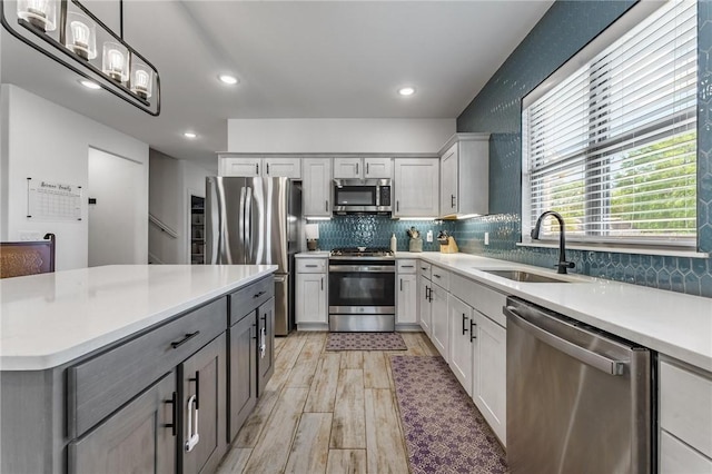 142 N Sheep Dog Ave, Farmington, AR 72730 - kitchen with a sink, tasteful backsplash, light countertops, and appliances with stainless steel finishes