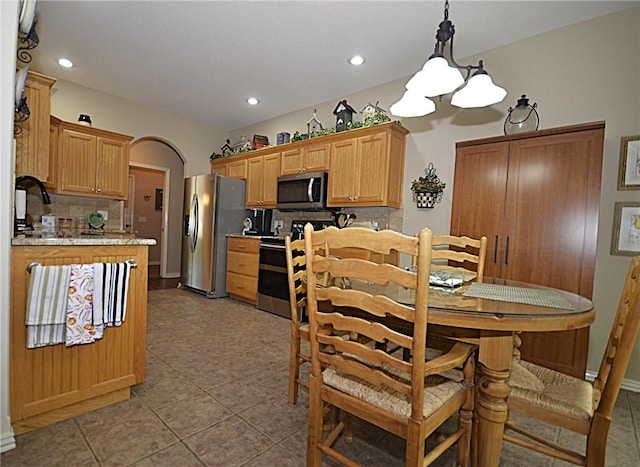 42 Sable Dr, Bella Vista, AR 72715 - dining room with a notable chandelier, arched walkways, light tile patterned floors, and recessed lighting