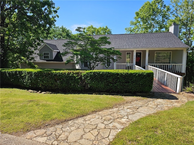 2341 N Fox Trl, Fayetteville, AR 72703 - view of front facade with a chimney, a front yard, a porch, and a shingled roof