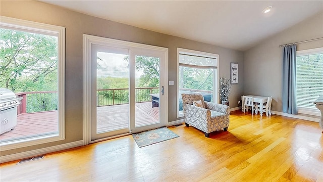 2341 N Fox Trl, Fayetteville, AR 72703 - doorway to outside featuring light wood finished floors, lofted ceiling, baseboards, and visible vents