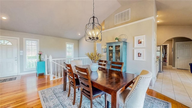 2341 N Fox Trl, Fayetteville, AR 72703 - dining space with lofted ceiling, a wealth of natural light, an inviting chandelier, visible vents, and arched walkways