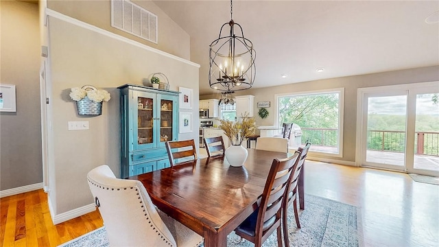 2341 N Fox Trl, Fayetteville, AR 72703 - dining room with high vaulted ceiling, baseboards, visible vents, a notable chandelier, and light wood-style floors