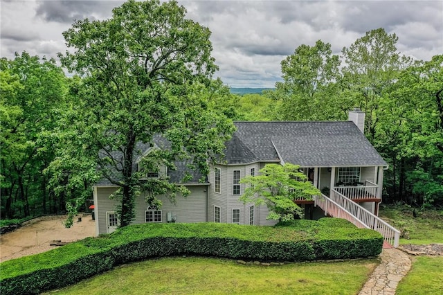 2341 N Fox Trl, Fayetteville, AR 72703 - view of front of house featuring a shingled roof, a chimney, and a front yard