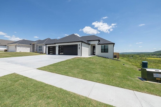 prairie-style house with a front lawn, an attached garage, and concrete driveway