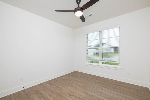 empty room with baseboards, a wealth of natural light, and a ceiling fan