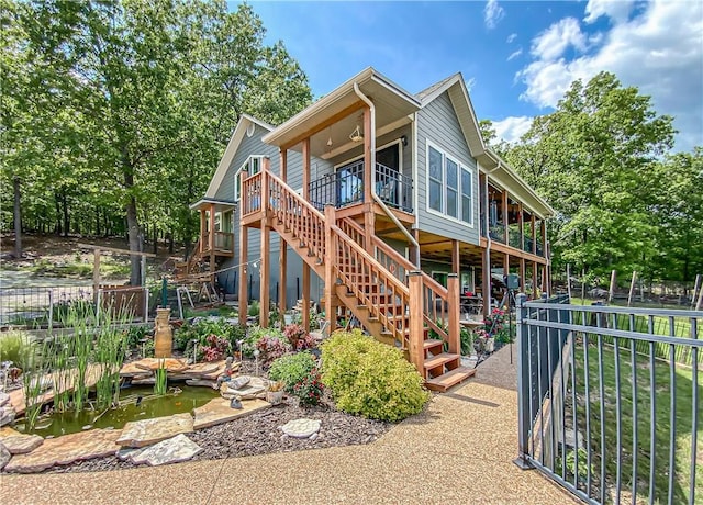 rear view of property with stairway and fence