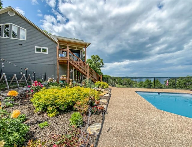 view of pool with stairway, a fenced backyard, and a fenced in pool