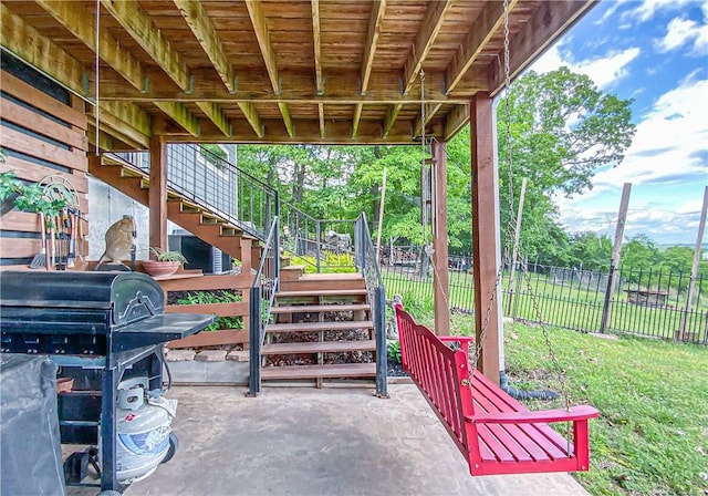 view of patio / terrace with grilling area, fence, and stairs