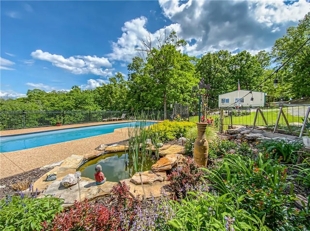 view of swimming pool featuring a fenced in pool and fence