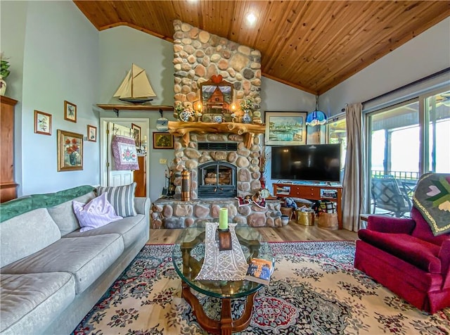 living area with wooden ceiling, a stone fireplace, high vaulted ceiling, and wood finished floors