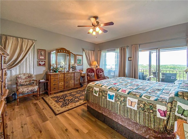 bedroom featuring access to outside, light wood-style flooring, and ceiling fan