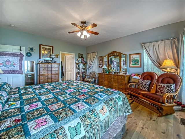 bedroom featuring a ceiling fan and wood finished floors