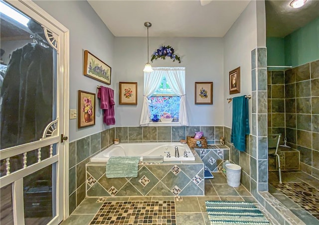 bathroom featuring walk in shower, tile patterned floors, and a bath