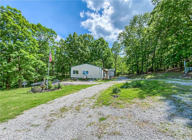 exterior space featuring driveway and a lawn
