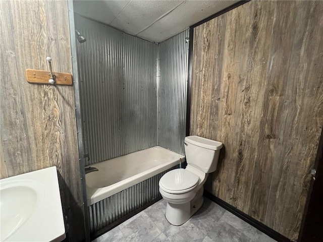 bathroom featuring toilet and wooden walls