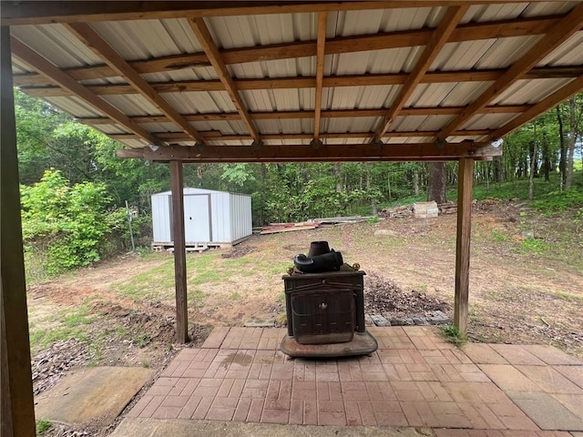 view of patio / terrace with a storage unit and an outdoor structure