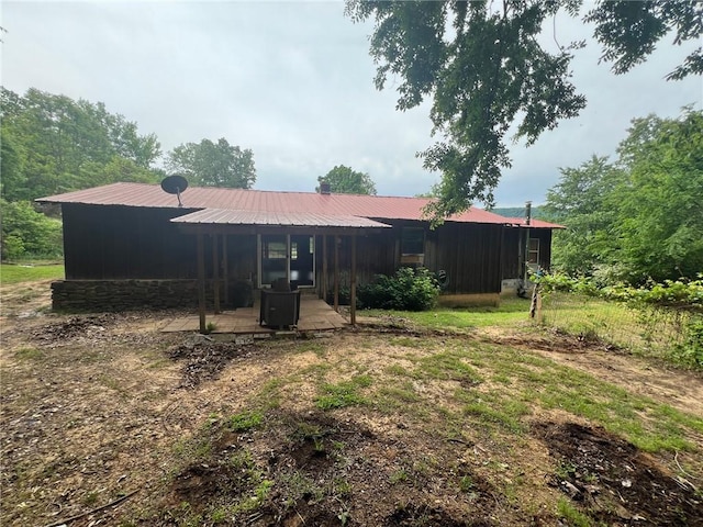 back of house with metal roof