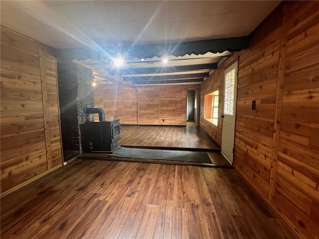 hall with dark wood-style flooring and wooden walls