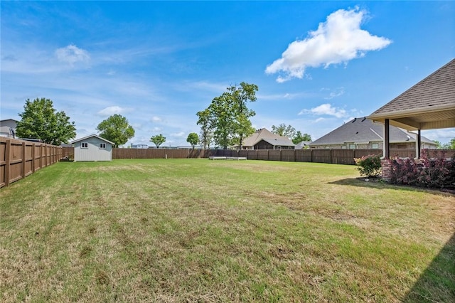 252 Forza Ln, Tontitown, AR 72762 - view of yard featuring an outbuilding, a storage shed, and a fenced backyard