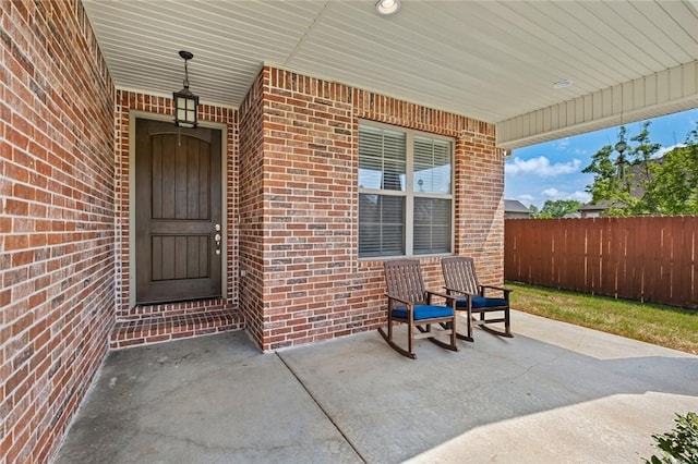 252 Forza Ln, Tontitown, AR 72762 - property entrance featuring fence and brick siding