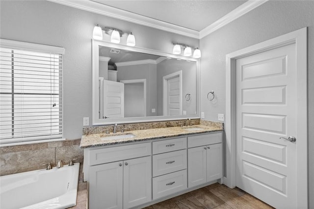252 Forza Ln, Tontitown, AR 72762 - bathroom with a sink, crown molding, double vanity, and a bath