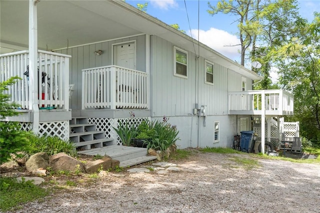 view of side of home featuring stairs