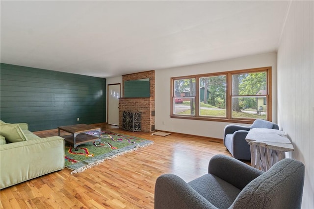 5 College St, Eureka Springs, AR 72632 - living area featuring wood finished floors, wood walls, a fireplace, and baseboards