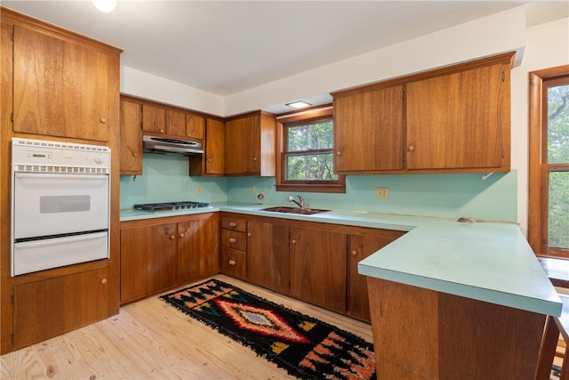 5 College St, Eureka Springs, AR 72632 - kitchen featuring white oven, a warming drawer, under cabinet range hood, a sink, and stainless steel gas stovetop