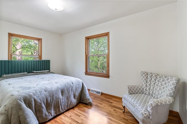5 College St, Eureka Springs, AR 72632 - bedroom featuring multiple windows, wood finished floors, and baseboards