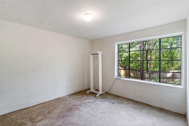 5 College St, Eureka Springs, AR 72632 - empty room featuring unfinished concrete floors and concrete block wall