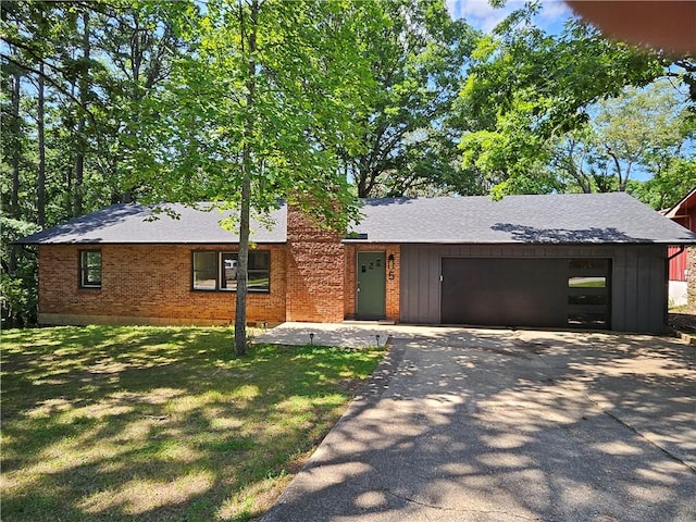 5 College St, Eureka Springs, AR 72632 - view of front of home featuring driveway, a garage, a shingled roof, and brick siding