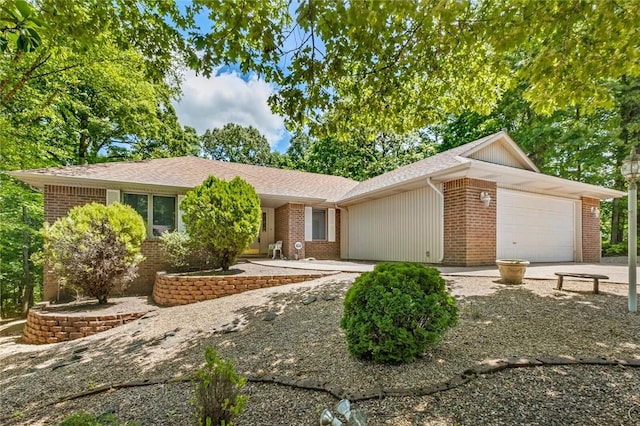 4 Tisbury Ln, Bella Vista, AR 72715 - ranch-style house with a garage, brick siding, concrete driveway, and a shingled roof