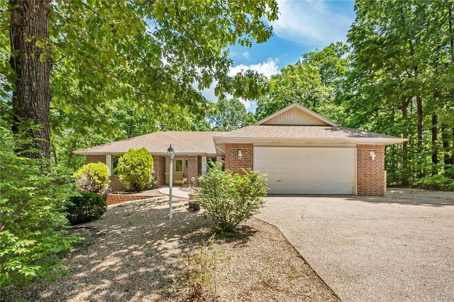 4 Tisbury Ln, Bella Vista, AR 72715 - single story home featuring driveway, a garage, brick siding, and roof with shingles