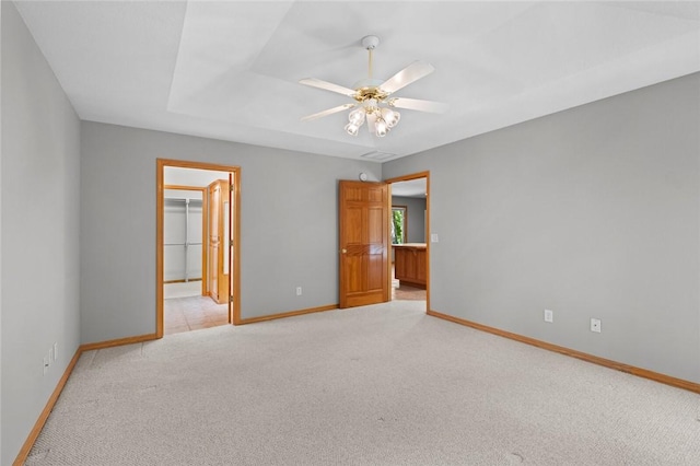 4 Tisbury Ln, Bella Vista, AR 72715 - unfurnished bedroom with light colored carpet, baseboards, a walk in closet, a closet, and ceiling fan