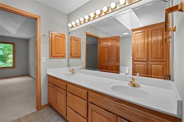 4 Tisbury Ln, Bella Vista, AR 72715 - bathroom with double vanity, toilet, tile patterned flooring, and baseboards