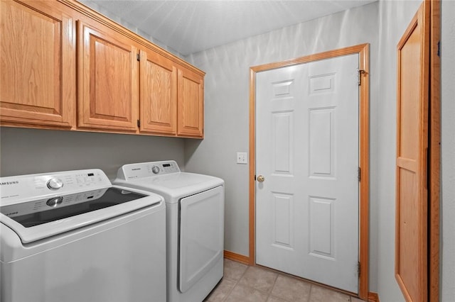 4 Tisbury Ln, Bella Vista, AR 72715 - laundry area with washing machine and dryer, cabinet space, light tile patterned floors, and baseboards