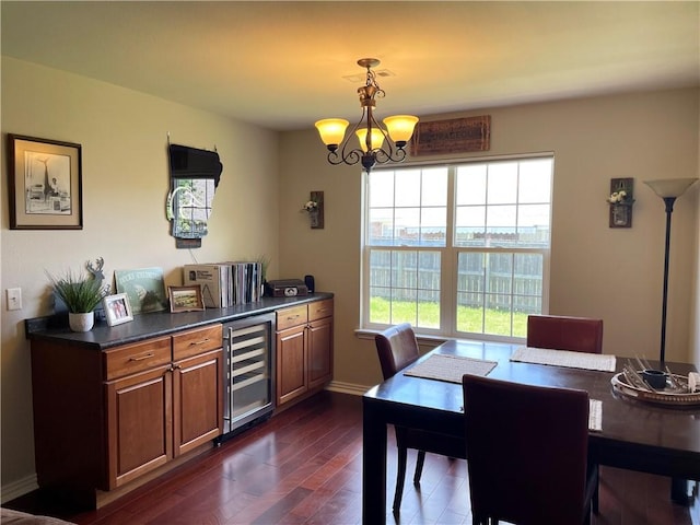 814 Irelan St, Lowell, AR 72745 - dining room featuring wine cooler, baseboards, a chandelier, and dark wood-style floors