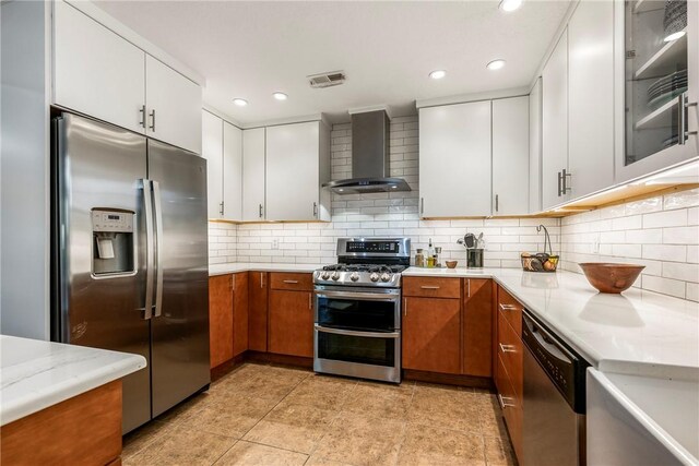 8 Eddy Ln, Bella Vista, AR 72715 - kitchen with appliances with stainless steel finishes, wall chimney exhaust hood, brown cabinetry, white cabinetry, and recessed lighting