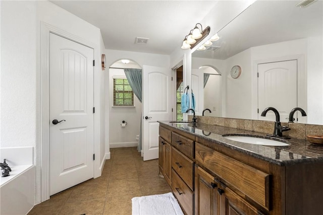 8 Eddy Ln, Bella Vista, AR 72715 - full bath with tile patterned floors, double vanity, a tub to relax in, and baseboards