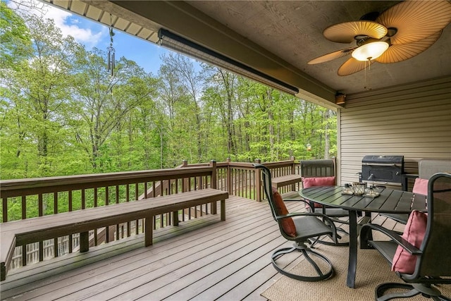 8 Eddy Ln, Bella Vista, AR 72715 - wooden terrace featuring grilling area, outdoor dining area, ceiling fan, and a wooded view