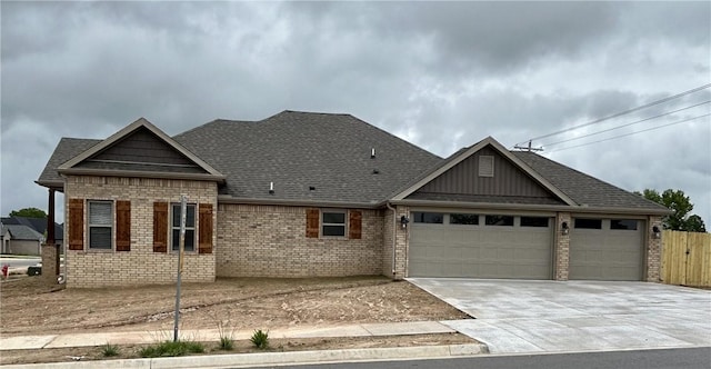 single story home with a garage, brick siding, concrete driveway, and fence