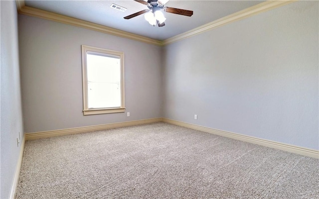spare room featuring ornamental molding, visible vents, ceiling fan, carpet floors, and baseboards