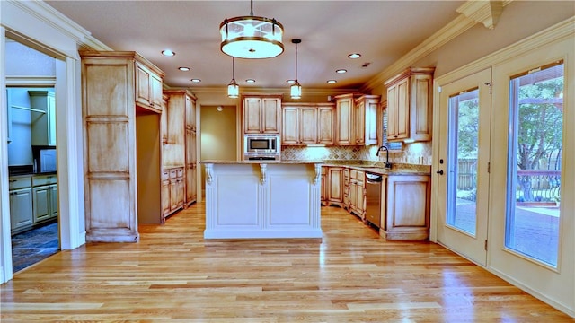 kitchen with light stone countertops, light wood-style flooring, a sink, crown molding, and appliances with stainless steel finishes